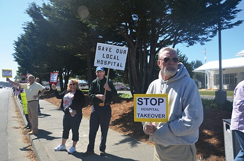 Residents of Crescent City, California line the streets to demonstrate their opposition to the attempt by Sutter Health to put their local hospital, the only hospital in a more than 80-mile radius, under the jurisdiction of Sutter’s West Bay Region so they can cut the number of beds in half in order to glean more Medicare money despite the impact this would have on the local community.